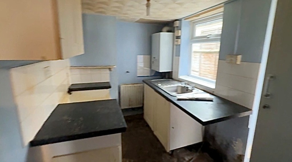 Lot: 162 - MID-TERRACE HOUSE FOR IMPROVEMENT - Kitchen with access to garden
